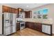 Well-lit kitchen features stainless steel appliances, granite countertops, and dark wood cabinetry at 1141 Abundance Dr, Locust Grove, GA 30248
