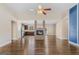 Spacious open-concept living room with hardwood floors, a modern fireplace, and recessed lighting at 1141 Abundance Dr, Locust Grove, GA 30248