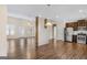 An open-concept living room with hardwood floors and natural light flowing through the window at 1141 Abundance Dr, Locust Grove, GA 30248