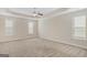 Large main bedroom offering ample space, carpet flooring, and a trey ceiling with fan at 1141 Abundance Dr, Locust Grove, GA 30248