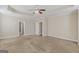 Spacious main bedroom featuring tray ceiling, neutral walls, carpet, and ensuite access at 1141 Abundance Dr, Locust Grove, GA 30248