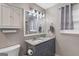 Bathroom features a double sink vanity with granite countertop, and a window at 1917 Lake Ridge Ct, Jonesboro, GA 30236
