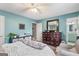 Cozy bedroom features a turquoise accent wall, and a queen-sized bed at 1917 Lake Ridge Ct, Jonesboro, GA 30236