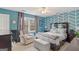 Bedroom features blue accent wall, a window, chair, and a queen sized bed at 1917 Lake Ridge Ct, Jonesboro, GA 30236