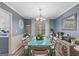 Bright dining room featuring a large table, stylish decor, and view into the kitchen at 1917 Lake Ridge Ct, Jonesboro, GA 30236