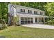 View of the house with a garage and a wooden staircase leading to the backyard at 1917 Lake Ridge Ct, Jonesboro, GA 30236
