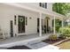 Inviting covered front porch features seating, greenery, and a welcoming entrance with a wreath and 'Welcome' sign at 1917 Lake Ridge Ct, Jonesboro, GA 30236