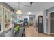 Galley kitchen with stainless appliances, modern lighting, white cabinetry, and wood flooring at 1917 Lake Ridge Ct, Jonesboro, GA 30236