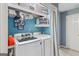 Laundry area features updated washer and dryer, built-in shelving, and blue paint at 1917 Lake Ridge Ct, Jonesboro, GA 30236