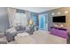 View of the living room area with gray sofa, window and purple drawers at 1917 Lake Ridge Ct, Jonesboro, GA 30236