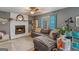 Cozy living room features a stone fireplace, hardwood floors, and comfortable grey sectional at 1917 Lake Ridge Ct, Jonesboro, GA 30236