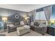 Cozy living room featuring gray sofas, stylish curtains, and elegant decor with great natural light at 1917 Lake Ridge Ct, Jonesboro, GA 30236