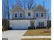 Charming two-story home featuring a spacious two-car garage and neutral color scheme at 99 Cooperton, Villa Rica, GA 30180