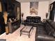 Comfortable living room with leather sofas, decorative fireplace, and an artistic flair at 99 Cooperton, Villa Rica, GA 30180