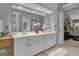 Spacious bathroom with double sinks, a large mirror, and a view into the luxurious, carpeted main bedroom at 120 Masters N Dr, Peachtree City, GA 30269