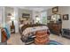 Comfortable bedroom with lots of pillows, a view to the outside and stacks of suitcases on the floor at 120 Masters N Dr, Peachtree City, GA 30269