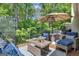 Relaxing deck with lounge furniture, side tables, and view of the surrounding trees at 120 Masters N Dr, Peachtree City, GA 30269