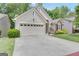 Classic home featuring a spacious driveway and well-kept landscaping at 120 Masters N Dr, Peachtree City, GA 30269