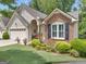 Charming home boasts manicured landscaping, a brick facade, and a welcoming covered entrance at 120 Masters N Dr, Peachtree City, GA 30269
