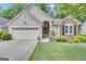 Charming home with a two-car garage, manicured lawn and a welcoming front porch at 120 Masters N Dr, Peachtree City, GA 30269