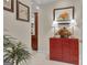 Hallway featuring a decorative red chest, floral arrangement, and framed art, adding charm at 120 Masters N Dr, Peachtree City, GA 30269