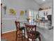 Charming kitchen island with granite countertop, stylish stools, and natural light at 120 Masters N Dr, Peachtree City, GA 30269