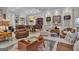 Spacious living room with custom built-ins, coffered ceilings, and cozy seating arrangement at 120 Masters N Dr, Peachtree City, GA 30269