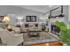 Comfortable living room features fireplace, hardwood floors, neutral decor, and lots of natural light at 120 Masters N Dr, Peachtree City, GA 30269