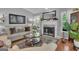 Cozy living room features a fireplace, plush sofa, and decorative accents at 120 Masters N Dr, Peachtree City, GA 30269