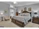 Spacious main bedroom featuring stylish furnishings and a walk-through to the ensuite bath at 120 Masters N Dr, Peachtree City, GA 30269