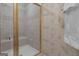 Shower stall with glass door, a built-in seat, and neutral tile at 120 Masters N Dr, Peachtree City, GA 30269