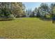 Expansive backyard, partially fenced, offering a large grassy area perfect for outdoor activities at 100 Clydesdale Ct, Tyrone, GA 30290