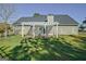 Backyard view featuring a pergola, and a well-maintained lawn at 100 Clydesdale Ct, Tyrone, GA 30290