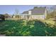 Spacious backyard featuring a lovely white pergola, well-maintained lawn, and secure black fencing at 100 Clydesdale Ct, Tyrone, GA 30290
