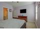 Large bedroom showcasing a TV, a queen sized bed, and access to an ensuite bathroom at 100 Clydesdale Ct, Tyrone, GA 30290