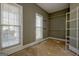 Spacious walk-in closet with built-in shelving and natural light from two windows at 100 Clydesdale Ct, Tyrone, GA 30290