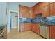 Charming kitchen features wooden cabinets, stainless steel appliances and blue tile backsplash at 100 Clydesdale Ct, Tyrone, GA 30290