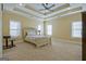 Spacious primary bedroom features tray ceilings, recessed lighting, and neutral carpeting at 100 Clydesdale Ct, Tyrone, GA 30290