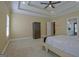 Bright primary bedroom features tray ceilings, recessed lighting, and neutral carpeting at 100 Clydesdale Ct, Tyrone, GA 30290