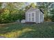 View of shed featuring double doors and a ramp, situated in a well-kept grassy yard at 100 Clydesdale Ct, Tyrone, GA 30290