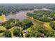 Aerial view of multiple properties near a lake, surrounded by lush trees and serene waterfront setting at 127 Darwish Dr, Mcdonough, GA 30252
