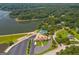 An elevated view of the community amenities featuring a clubhouse, tennis courts, and lakeside parking at 127 Darwish Dr, Mcdonough, GA 30252
