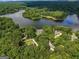 Aerial view of a home by the lake, surrounded by lush trees and providing a serene waterfront setting at 127 Darwish Dr, Mcdonough, GA 30252