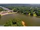 Aerial view of a lake, featuring a bridge, waterfront properties, and scenic natural surroundings at 127 Darwish Dr, Mcdonough, GA 30252
