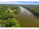 Expansive aerial view showcasing a serene lake surrounded by lush greenery and beautiful homes at 127 Darwish Dr, Mcdonough, GA 30252