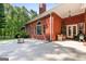 Covered backyard patio with wicker furniture and lush green landscaping at 127 Darwish Dr, Mcdonough, GA 30252