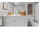 Bright bathroom featuring a large mirror, white cabinetry, and stylish decorative accents at 127 Darwish Dr, Mcdonough, GA 30252