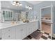 Modern bathroom with double vanity, checkered floor, and open access to bedroom at 127 Darwish Dr, Mcdonough, GA 30252