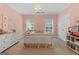 Charming bedroom with a chandelier, shuttered windows, and carpeted floors at 127 Darwish Dr, Mcdonough, GA 30252