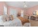 Comfortable bedroom with decorative chandelier, shuttered windows, and patterned bedding at 127 Darwish Dr, Mcdonough, GA 30252